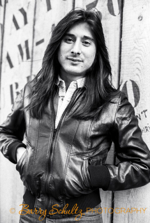 Musician Steve Perry of Journey leaning against KLM office wall in Amsterdam during the 1970s.
